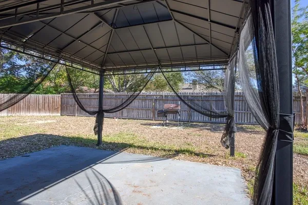 a view of a backyard with large tree