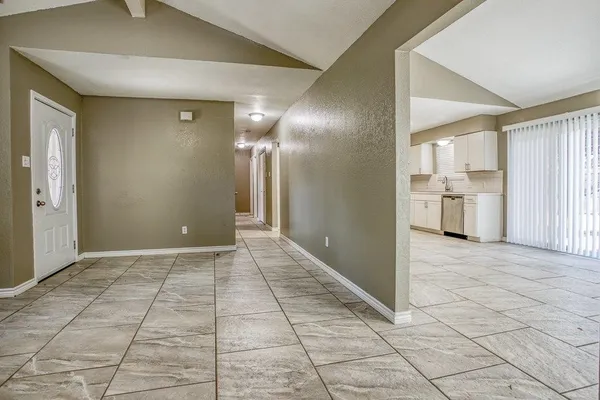 a view of a hallway to rooms