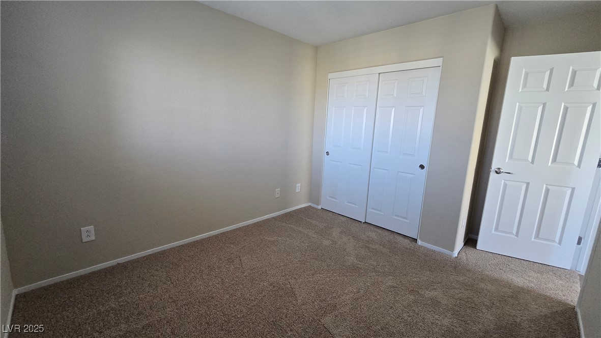 2737 Rimbaud Street Henderson, NV 89044 - Photo 29 of 49 Unfurnished bedroom featuring carpet flooring, a closet, and baseboards