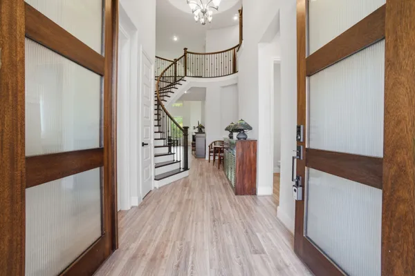 a view of an entryway with wooden floor