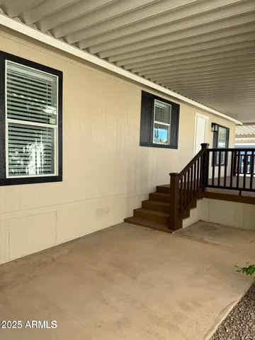 a view of a chair and table in the backyard