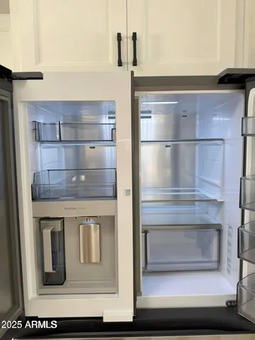 a kitchen with a refrigerator and cabinets