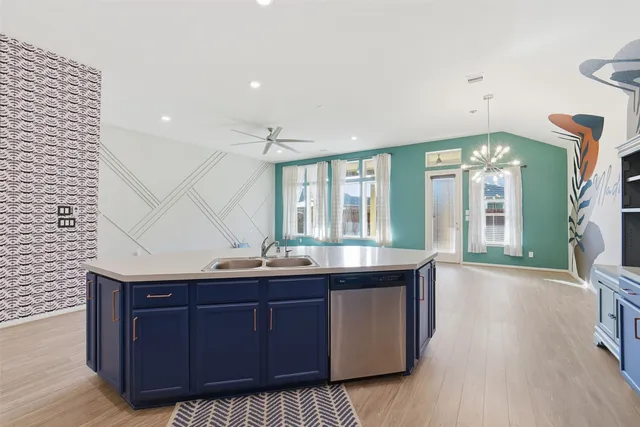 a kitchen with granite countertop a sink and cabinets