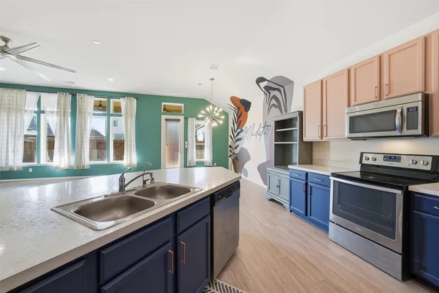 a kitchen with stainless steel appliances granite countertop a sink stove and cabinets