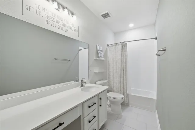 a bathroom with a double vanity sink toilet and shower