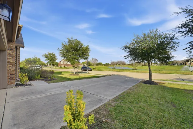 a view of yard with swimming pool and green space