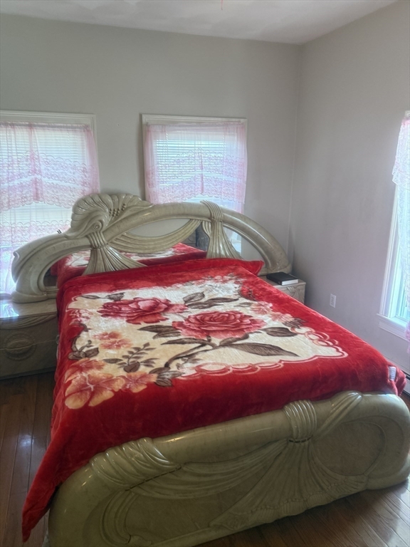 82 2nd Street Medford, MA 02155 - Photo 18 of 38 a bed with a pink blanket and pillows