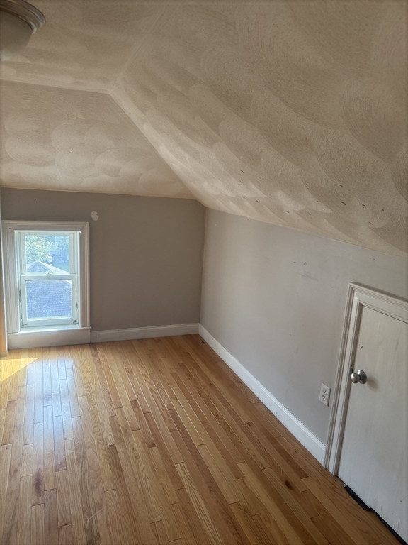 82 2nd Street Medford, MA 02155 - Photo 22 of 38 a view of an empty room and wooden floor