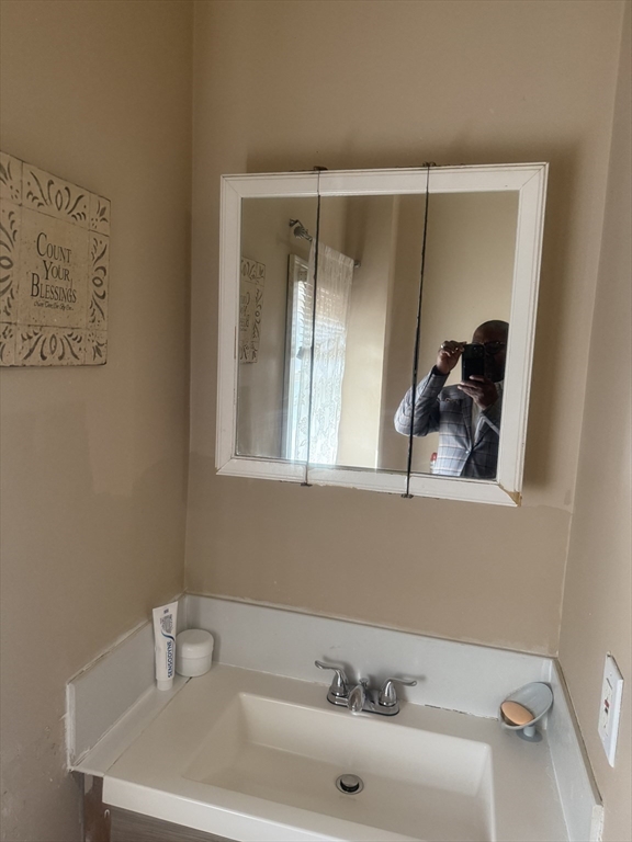 82 2nd Street Medford, MA 02155 - Photo 26 of 38 a bathroom with a sink and a window