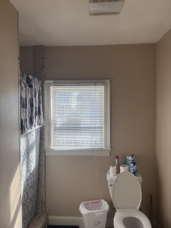 82 2nd Street Medford, MA 02155 - Photo 30 of 38 a bathroom with a toilet sink and mirror