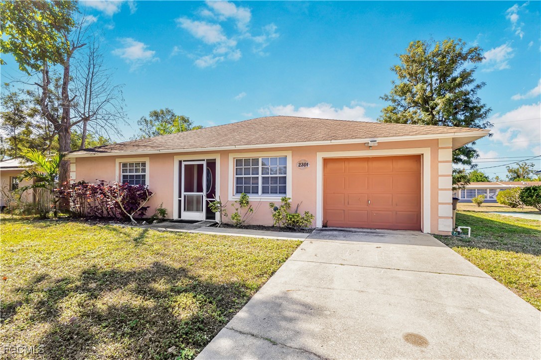 2301 Hibiscus Road Fort Myers, FL 33905 - Photo 1 of 40 a front view of a house with a garden and patio