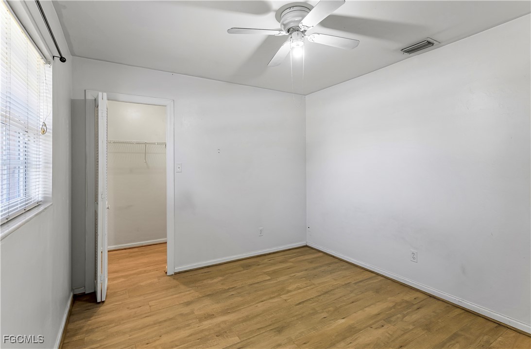 2301 Hibiscus Road Fort Myers, FL 33905 - Photo 19 of 40 an empty room with wooden floor closet and fan
