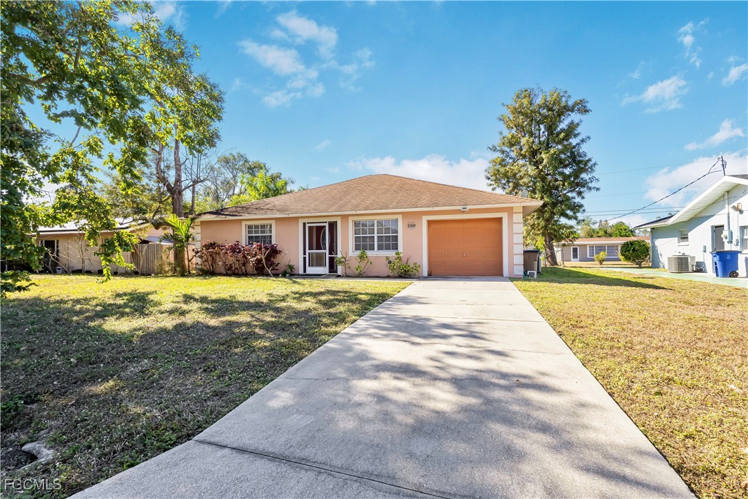 2301 Hibiscus Road Fort Myers, FL 33905 - Photo 2 of 40 a front view of a house with garden