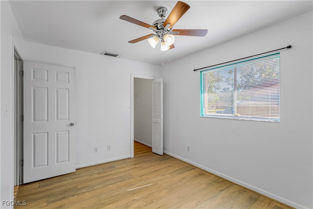 2301 Hibiscus Road Fort Myers, FL 33905 - Photo 22 of 40 wooden floor in an empty room with a window