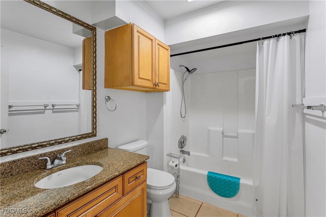 2301 Hibiscus Road Fort Myers, FL 33905 - Photo 23 of 40 a bathroom with a granite countertop sink toilet and shower