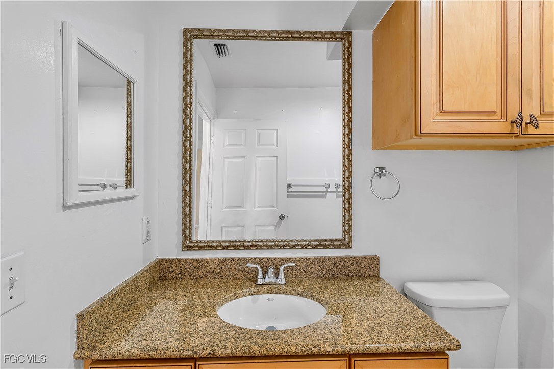 2301 Hibiscus Road Fort Myers, FL 33905 - Photo 24 of 40 a bathroom with a granite countertop sink and a mirror