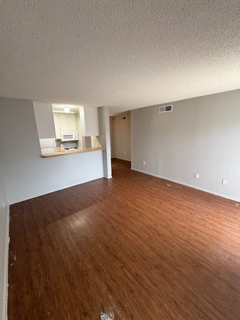 1810 North Garrett Avenue, Unit 106 Dallas, TX 75206 - Photo 3 of 9 an empty room with wooden floor and windows