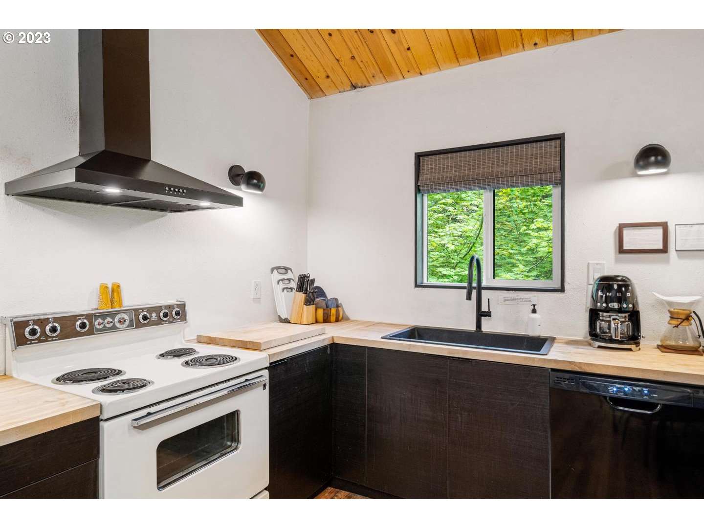 72715 East Village Loop Road Rhododendron, OR 97049 - Photo 13 of 48 a kitchen with a stove a sink and a microwave