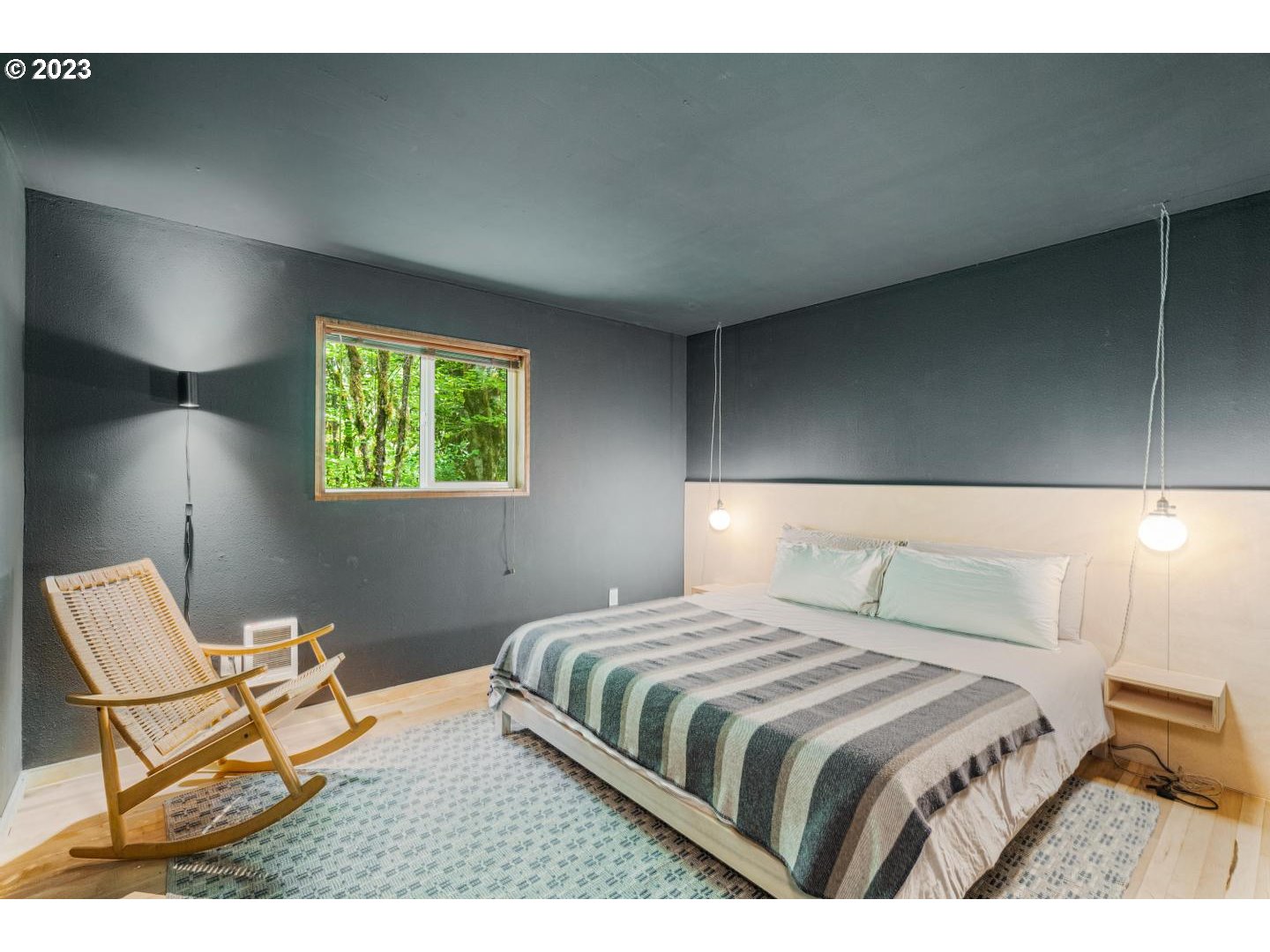 72715 East Village Loop Road Rhododendron, OR 97049 - Photo 17 of 48 a bedroom with a bed and a lamp