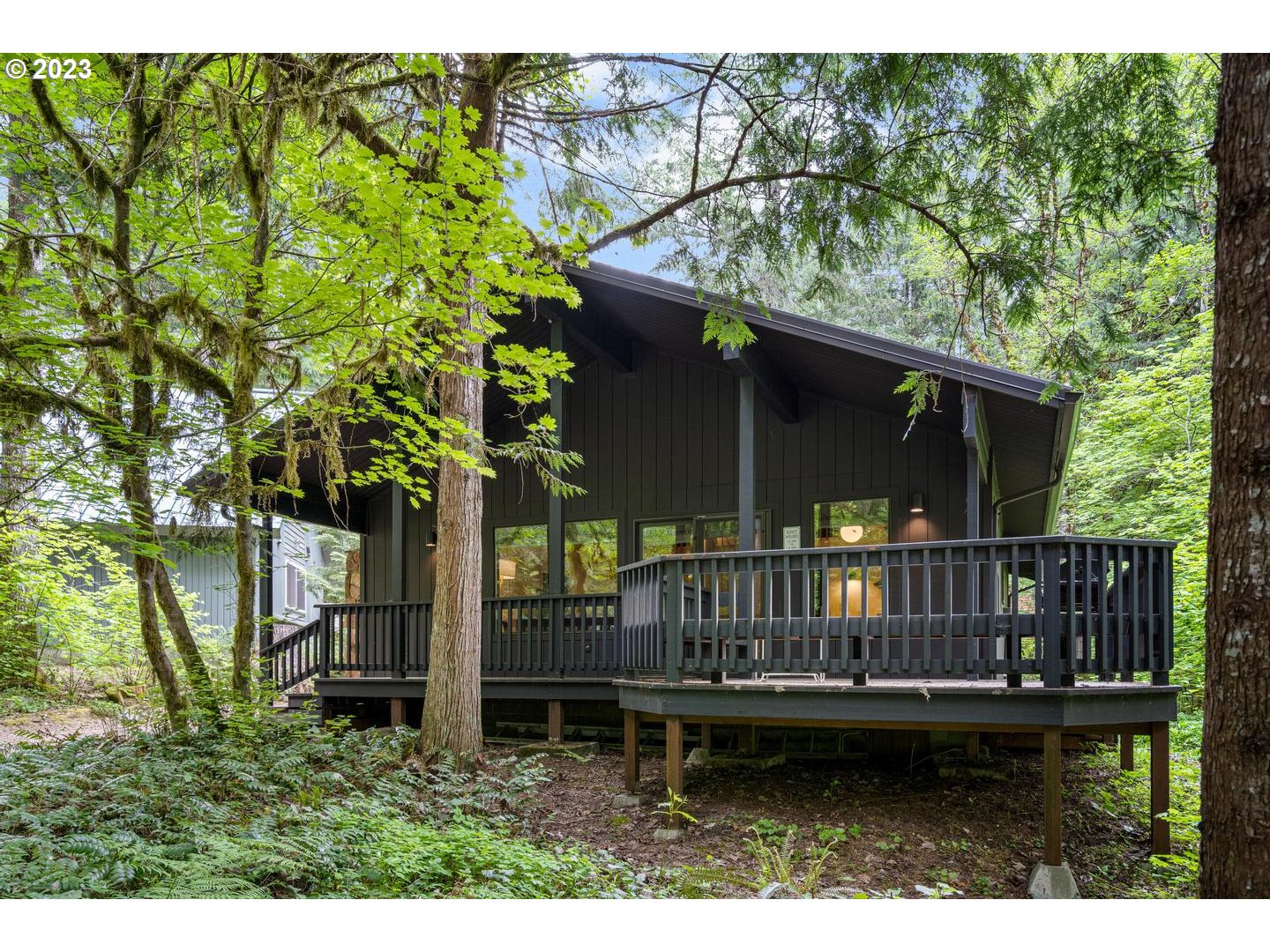 72715 East Village Loop Road Rhododendron, OR 97049 - Photo 2 of 48 a backyard of a house with lots of green space