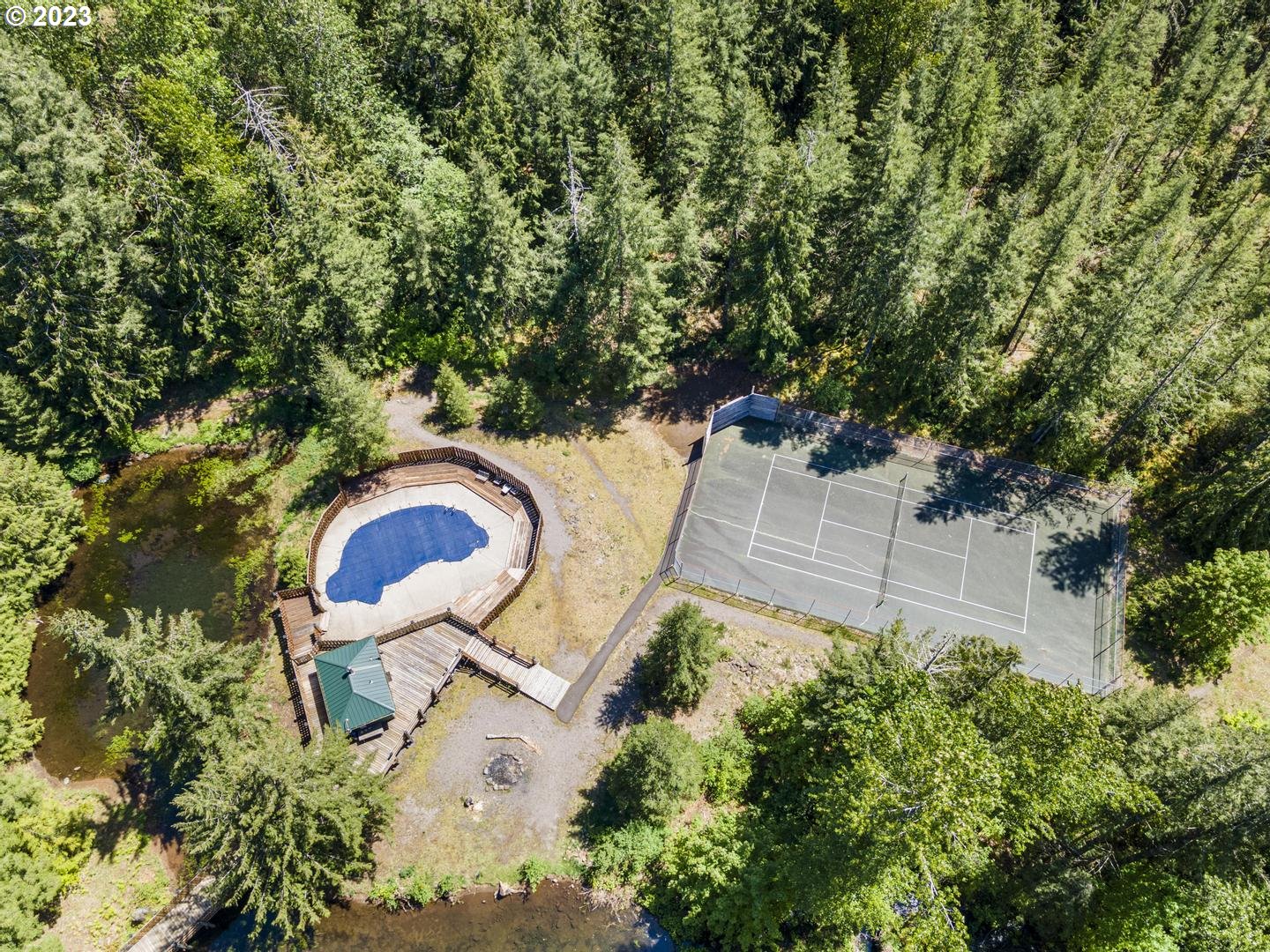 72715 East Village Loop Road Rhododendron, OR 97049 - Photo 44 of 48 an aerial view of a house with garden space and trees