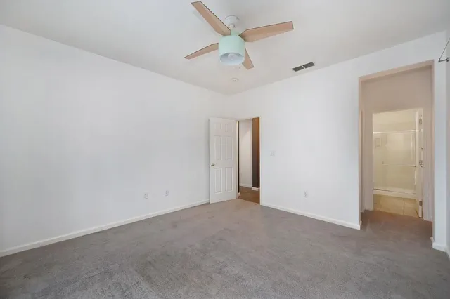 a bed room with a bed and a chandelier