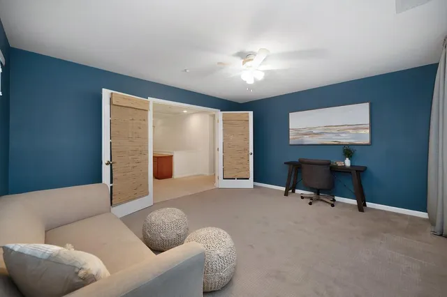 a view of a table and chairs under an umbrella in backyard