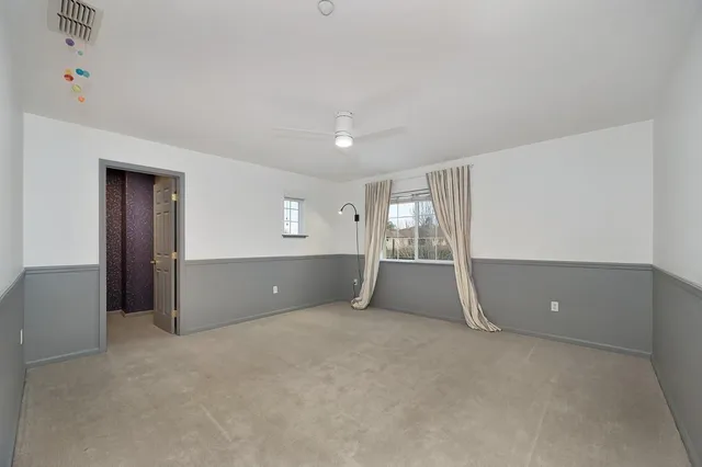 a view of a patio with a table and chairs under an umbrella