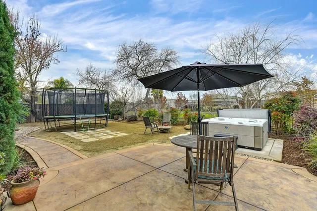 an aerial view of a house with a garden and lake view