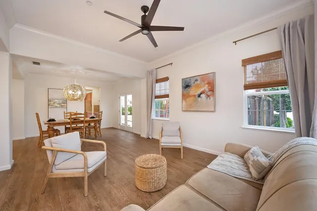 a dining room with furniture and wooden floor