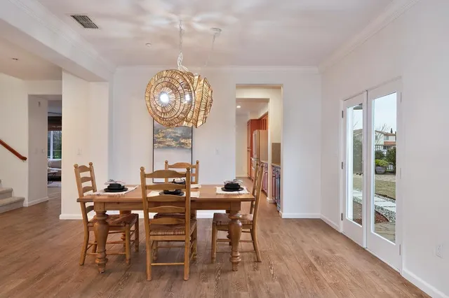 a large kitchen with kitchen island a sink a stove and a wooden floors