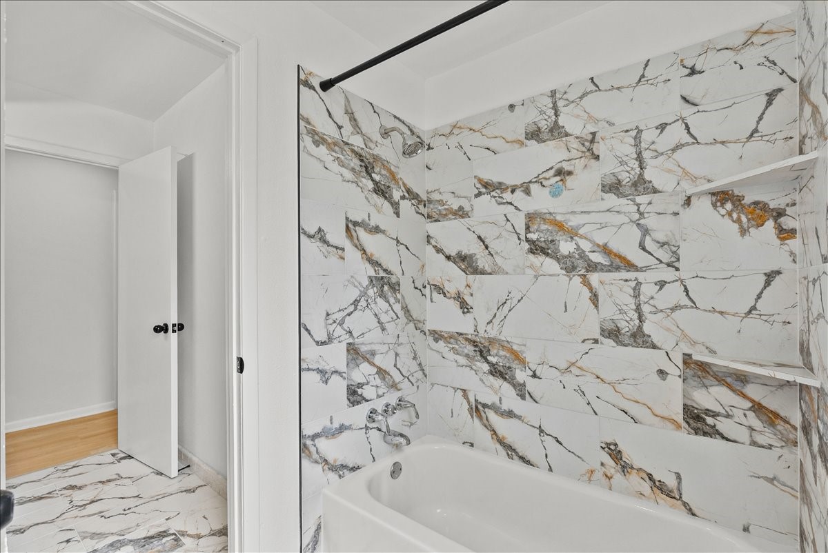 5762 Birdwood Road Houston, TX 77096 - Photo 21 of 50 NOTICE THE GORGEOUS TILED TUB/SHOWER COMBO.
