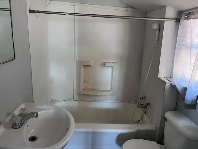 a bathroom with a sink and shower