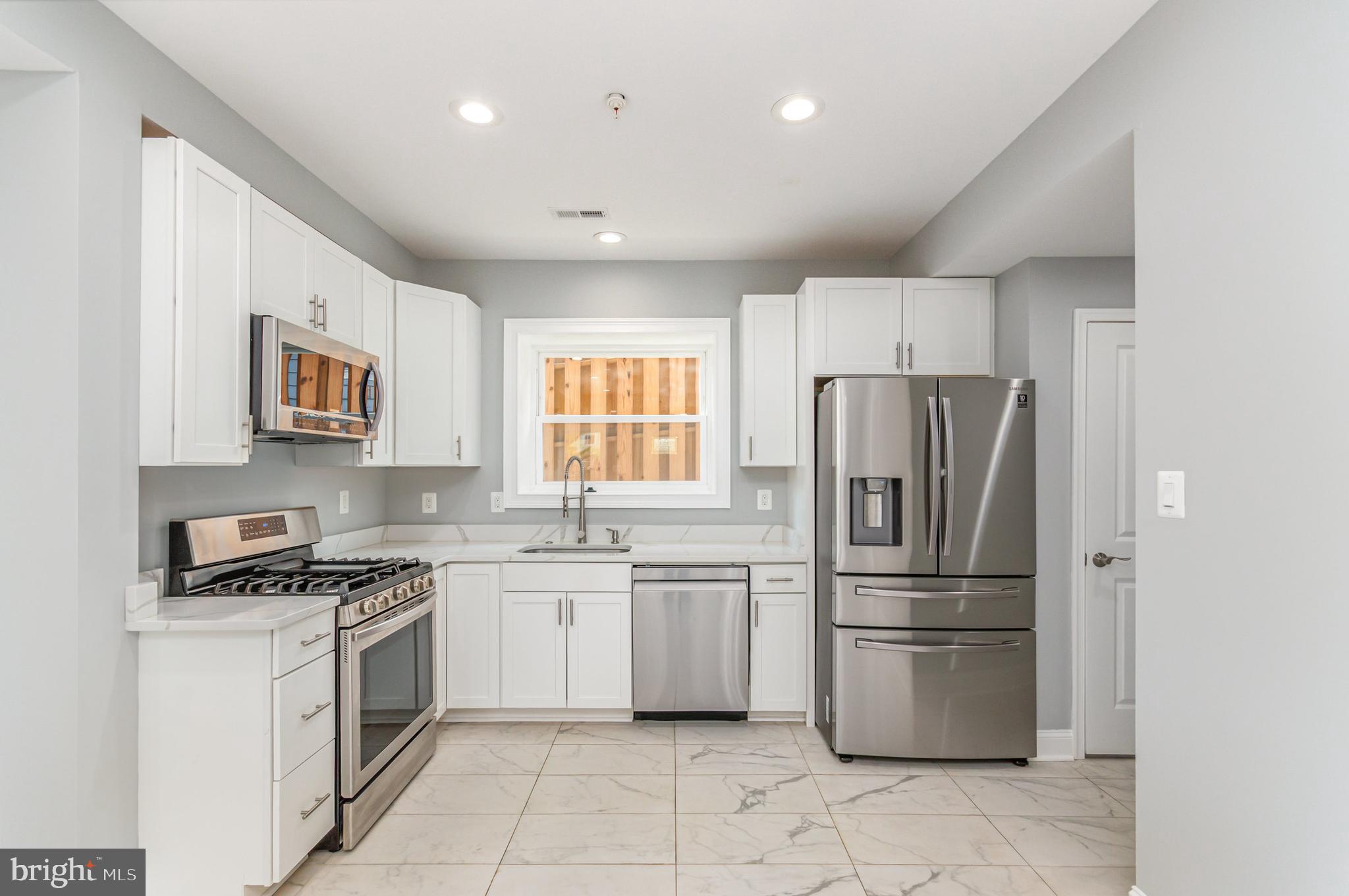 3110 Perry Street Mount Rainier, MD 20712 - Photo 2 of 24 a kitchen with a refrigerator sink and cabinets