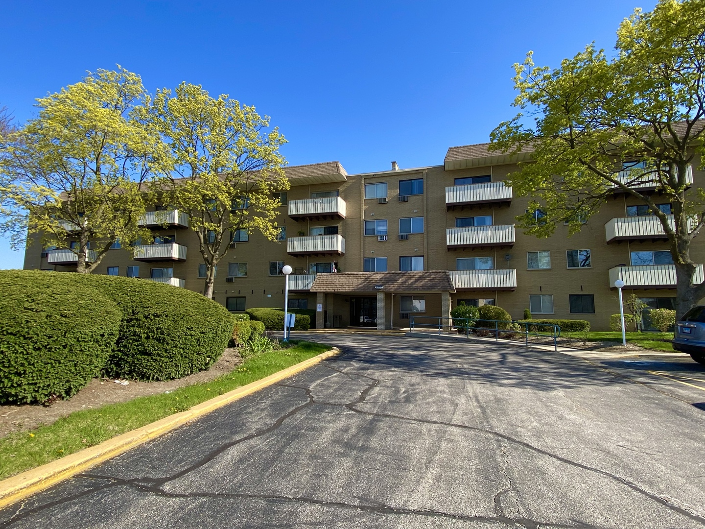 280 North Westgate Road, Unit 427 Mount Prospect, IL 60056 - Photo 1 of 23 a front view of a building with a garden