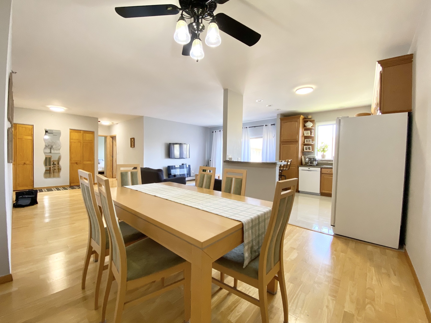 280 North Westgate Road, Unit 427 Mount Prospect, IL 60056 - Photo 6 of 23 a dining room with stainless steel appliances a table chairs and a refrigerator