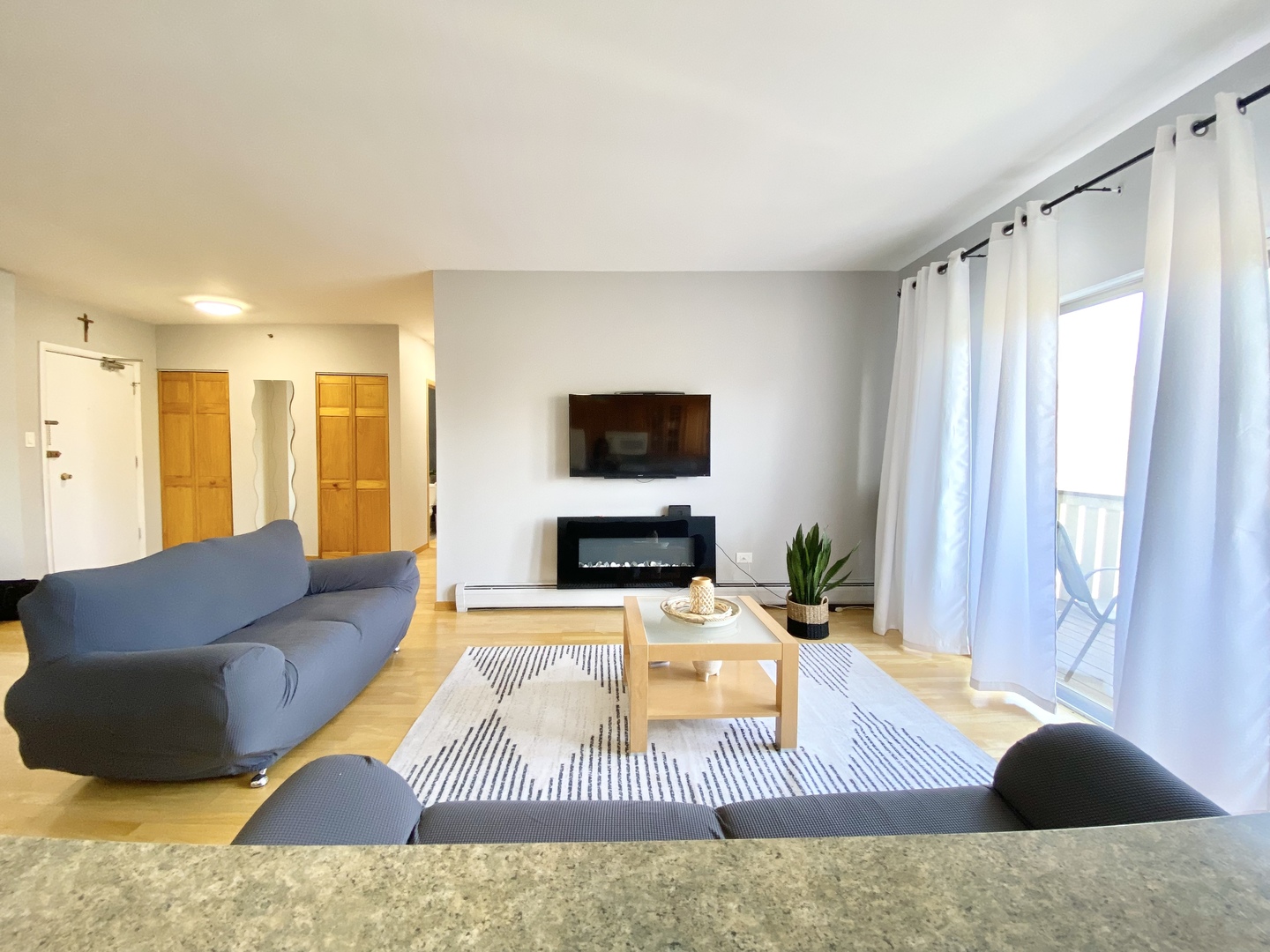 280 North Westgate Road, Unit 427 Mount Prospect, IL 60056 - Photo 7 of 23 a living room with furniture and a flat screen tv