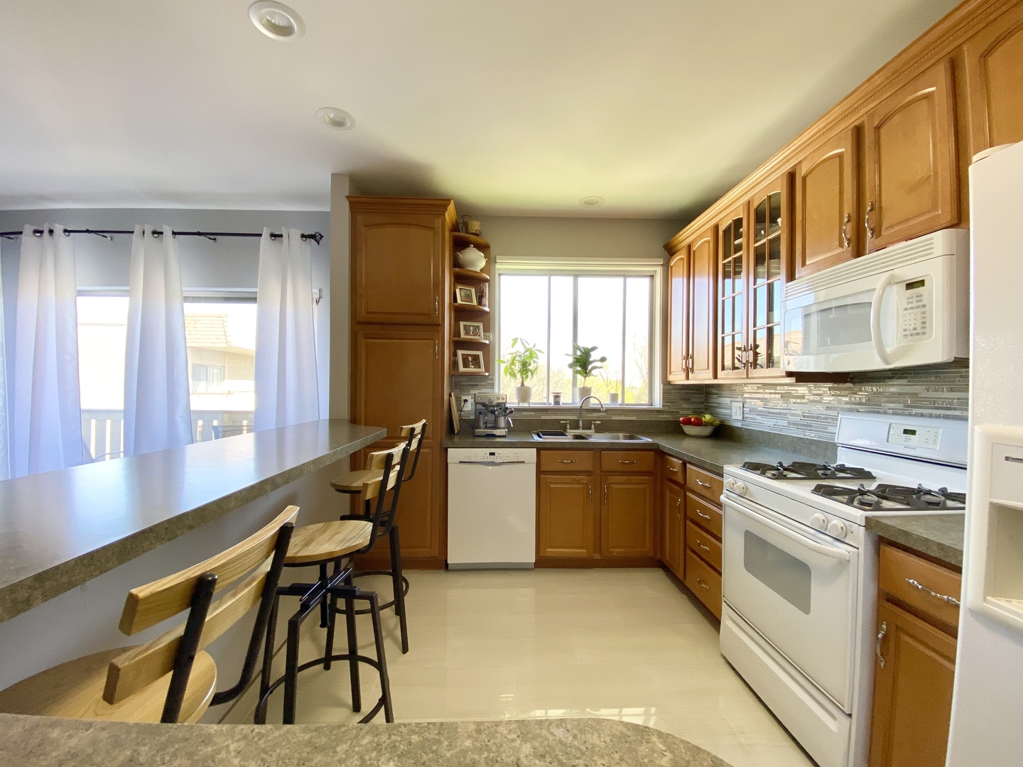 280 North Westgate Road, Unit 427 Mount Prospect, IL 60056 - Photo 10 of 23 a kitchen with a stove a sink and a refrigerator