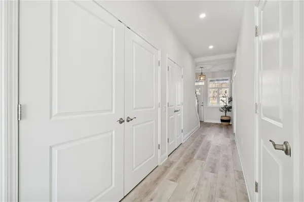 a view of a hallway with wooden floor