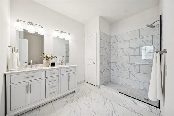 a bathroom with a double vanity sink a toilet and a mirror