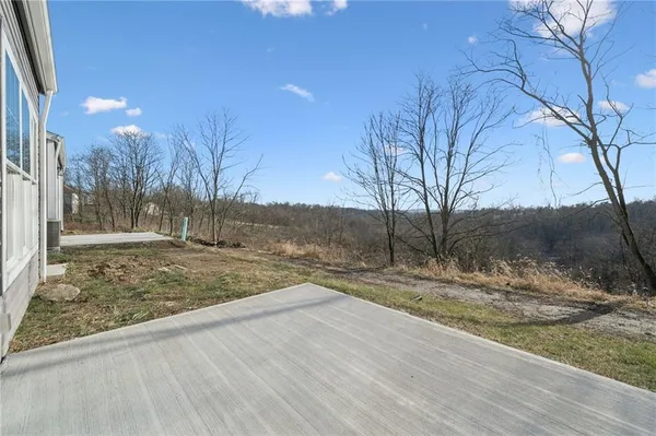 a view of a yard with wooden fence