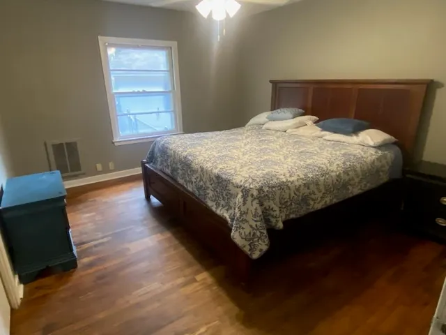 a bed sitting in a bedroom next to a window