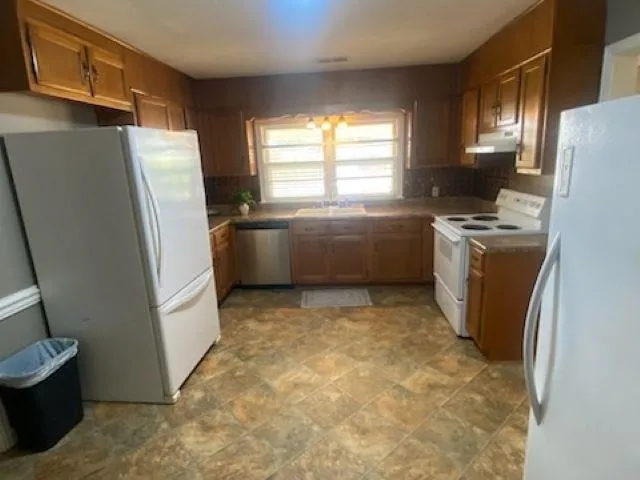 a room with refrigerator and washer