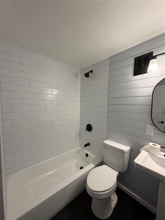 320 Lakeview Street, Unit 220 Orlando, FL 32804 - Photo 8 of 11 a white toilet sitting next to a bath tub