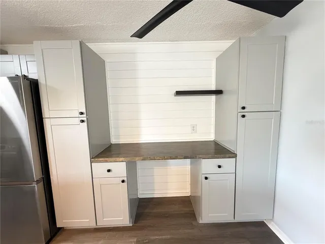 a kitchen with a sink and a refrigerator