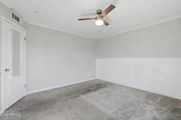 a view of an empty room with a fan