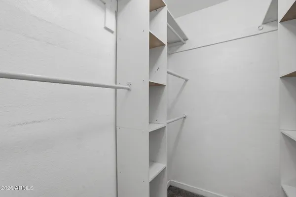 a bedroom with a bed and a mirror