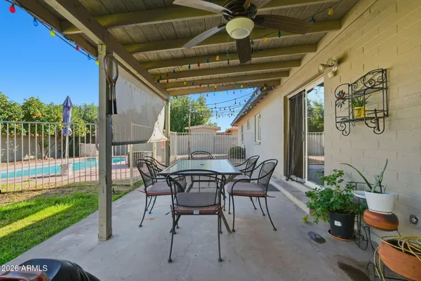 a backyard of a house with table and chairs