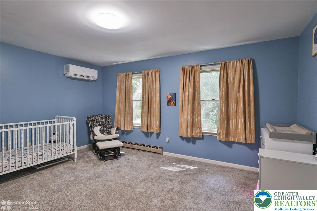 60 Sassafras Road Lehighton, PA 18235 - Photo 27 of 36 A well-lit bedroom features plush carpeting and multiple windows.