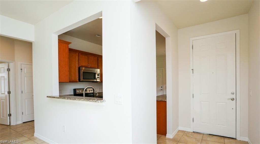 8482 Karina Court Naples, FL 34114 - Photo 13 of 40 a living room with a bed and a dresser